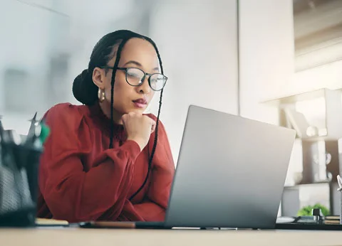 Businesswoman looking at startup web design solutions in Johannesburg on a computer